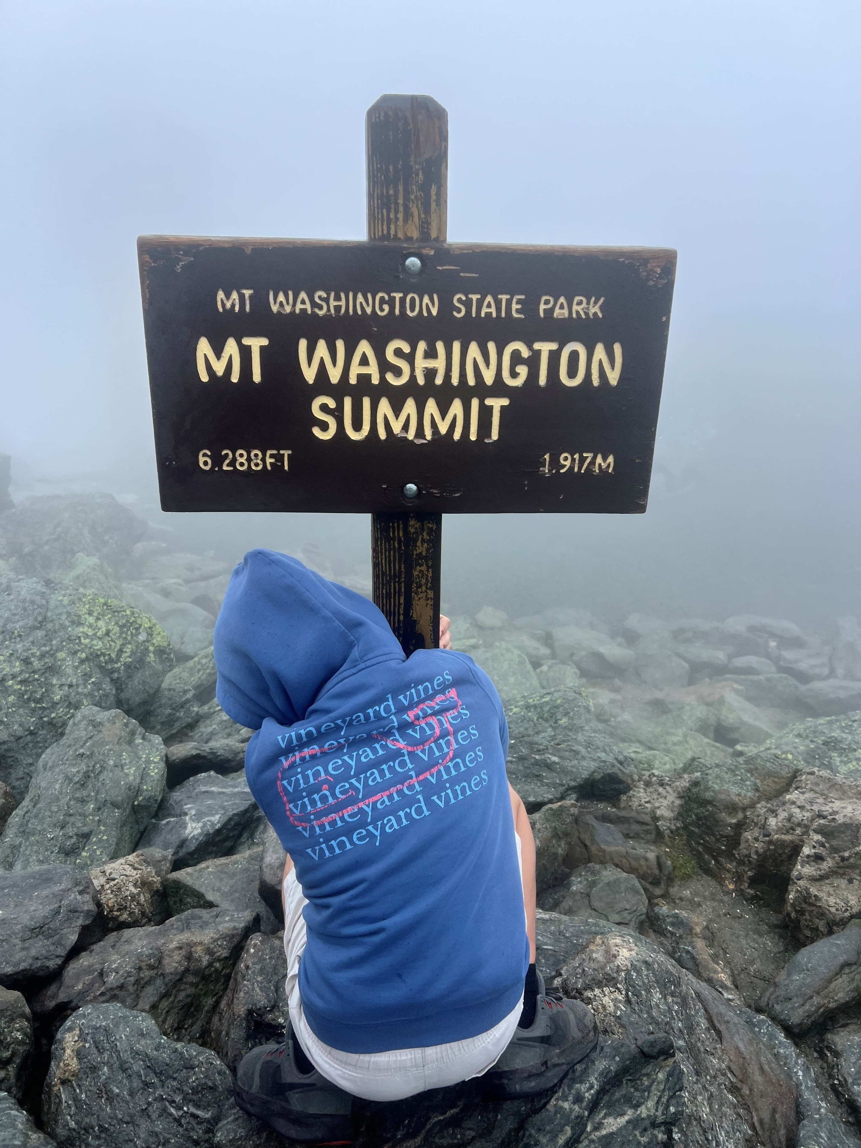 Summit sign at Mt. Washington — 70 mph gusts and zero visibility. Absolutely worth it.